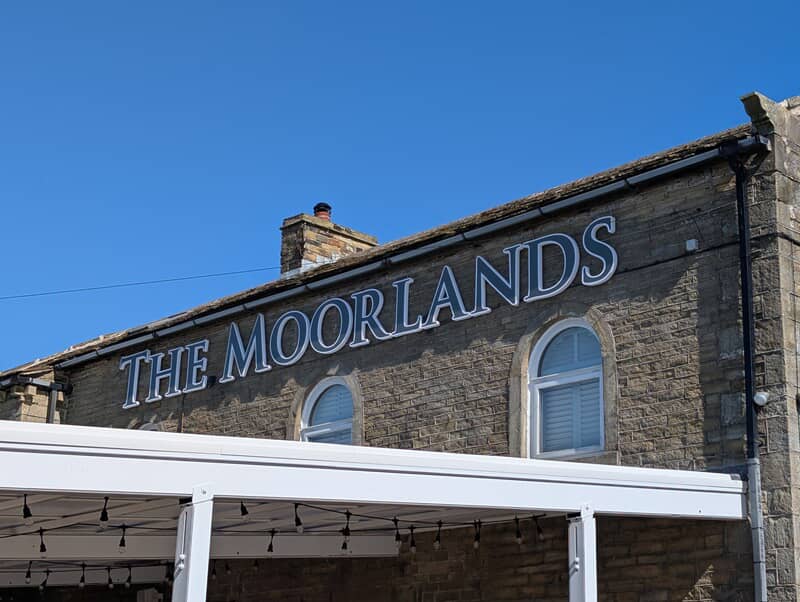 An image of The Moorlands signage at the top of the building.